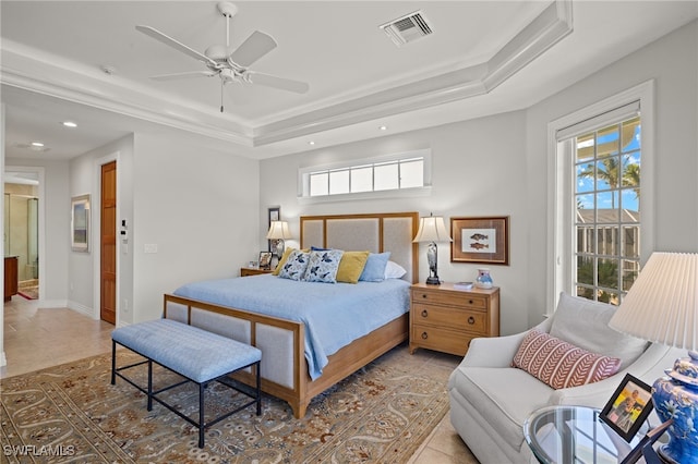 tiled bedroom with a raised ceiling, ceiling fan, and ornamental molding