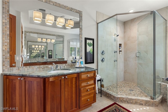 bathroom with tile patterned flooring, vanity, and an enclosed shower