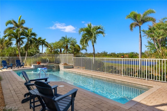 view of pool with an in ground hot tub and a patio