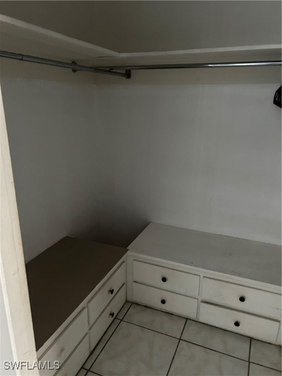 spacious closet with light tile patterned floors