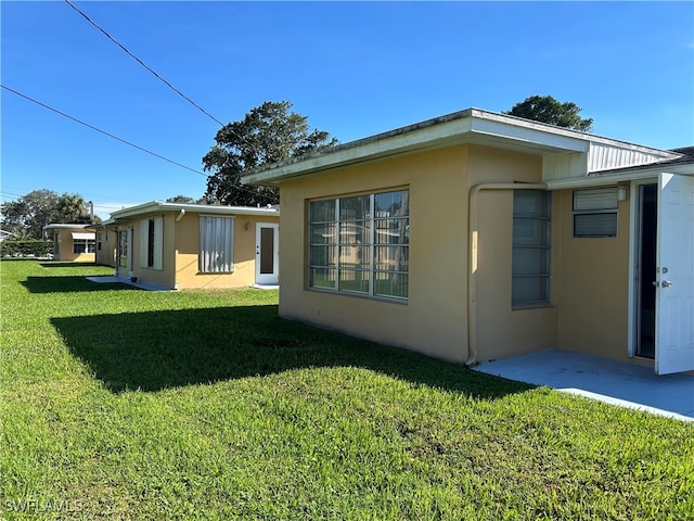 view of property exterior with a yard