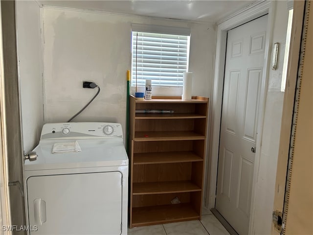 clothes washing area featuring washer / clothes dryer and light tile patterned floors