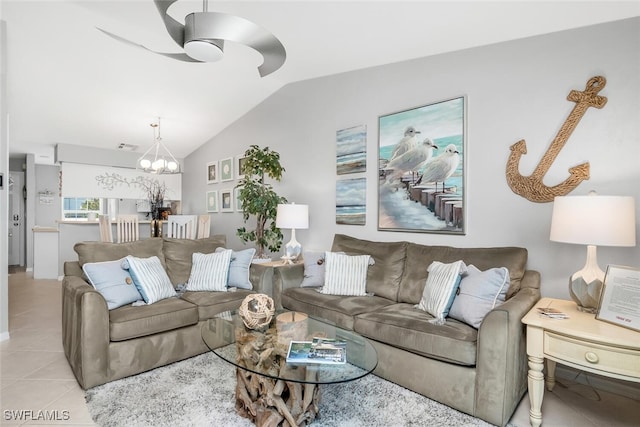 tiled living room featuring ceiling fan with notable chandelier and vaulted ceiling