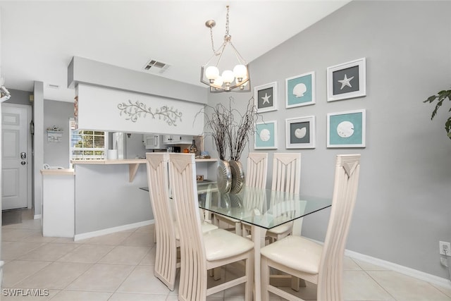 tiled dining area with an inviting chandelier