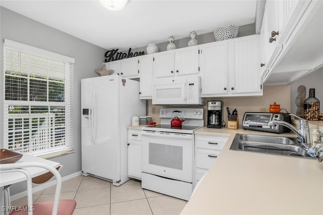 kitchen featuring sink, white cabinets, light tile patterned flooring, and white appliances