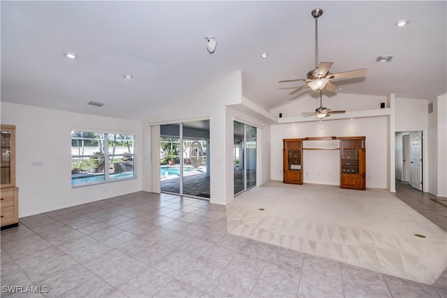 unfurnished living room featuring ceiling fan, lofted ceiling, and light tile patterned flooring