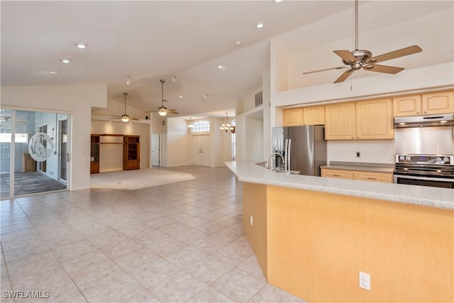 kitchen with light brown cabinets, ceiling fan with notable chandelier, sink, vaulted ceiling, and stainless steel appliances