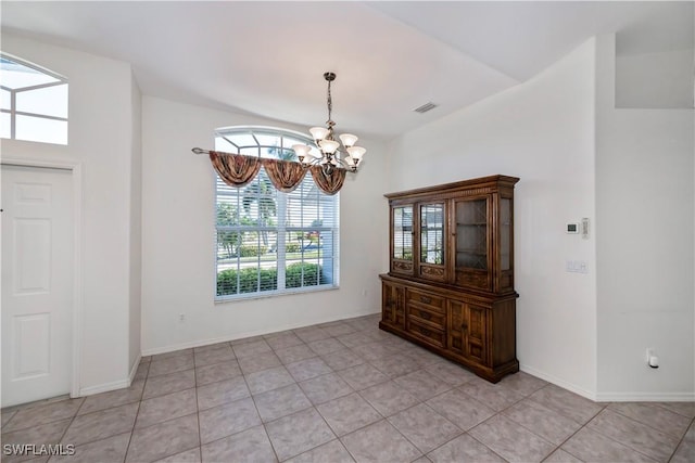 unfurnished dining area with light tile patterned flooring and a chandelier