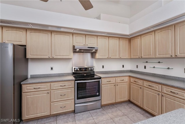 kitchen with ceiling fan, light brown cabinets, stainless steel appliances, a towering ceiling, and light tile patterned flooring