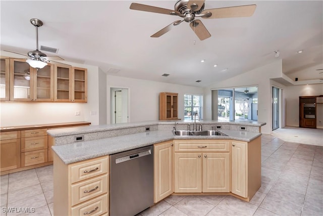 kitchen featuring dishwasher, a center island, lofted ceiling, sink, and light stone countertops