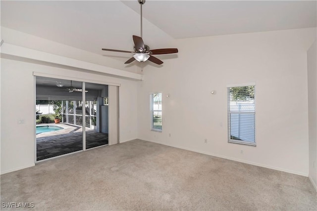 empty room with ceiling fan, light colored carpet, and lofted ceiling