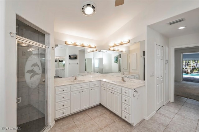 bathroom with ceiling fan, walk in shower, tile patterned floors, vaulted ceiling, and vanity