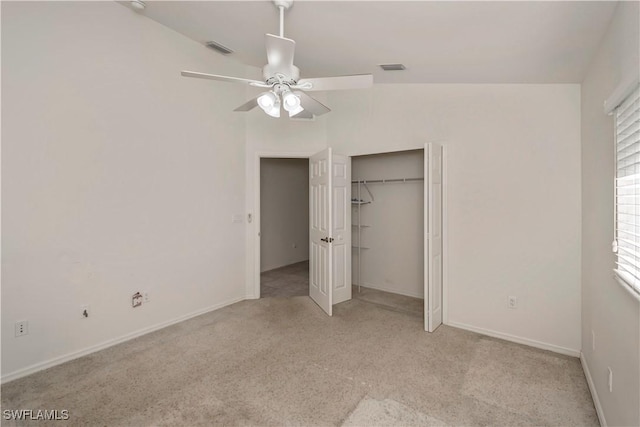 unfurnished bedroom featuring ceiling fan, a closet, and light colored carpet