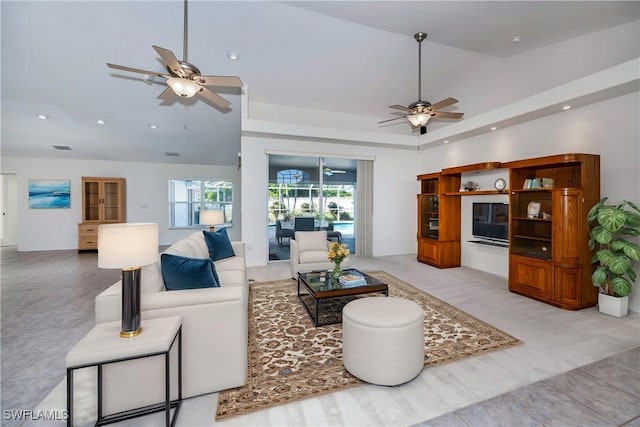 living room featuring ceiling fan and lofted ceiling