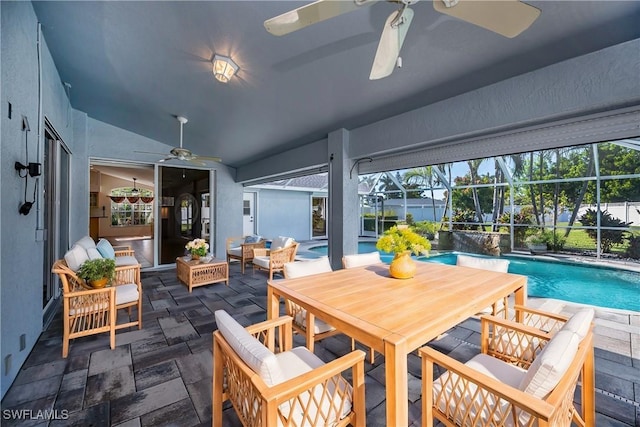 interior space with glass enclosure, ceiling fan, and an outdoor hangout area