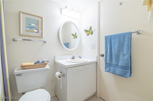 bathroom featuring tile patterned floors, vanity, and toilet