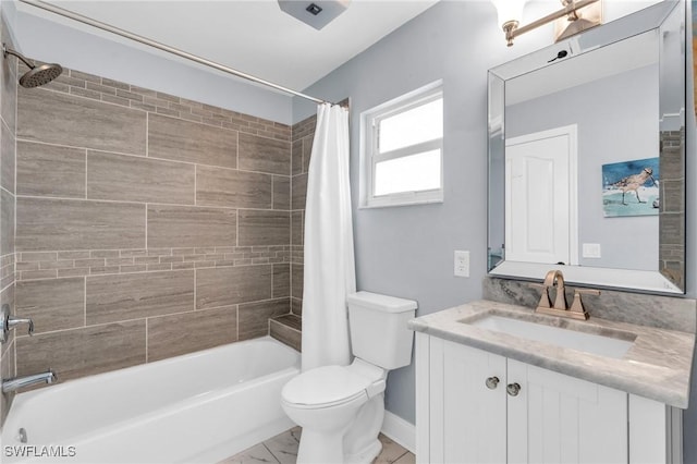 full bathroom featuring toilet, shower / bath combo with shower curtain, and vanity