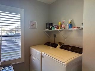 clothes washing area featuring washer and dryer