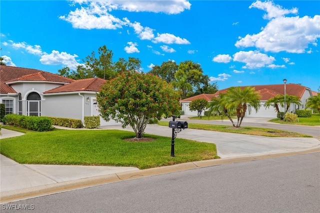 mediterranean / spanish house with a front yard