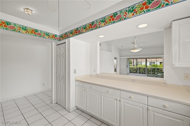 kitchen with white cabinetry and light tile patterned floors