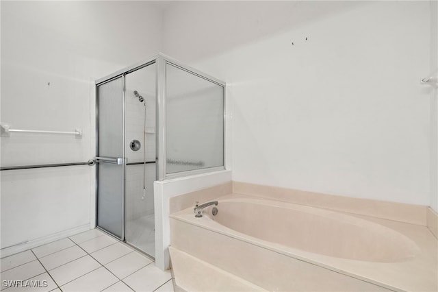 bathroom featuring tile patterned flooring and separate shower and tub