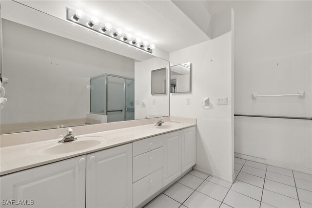 bathroom with tile patterned flooring, vanity, and a shower with shower door