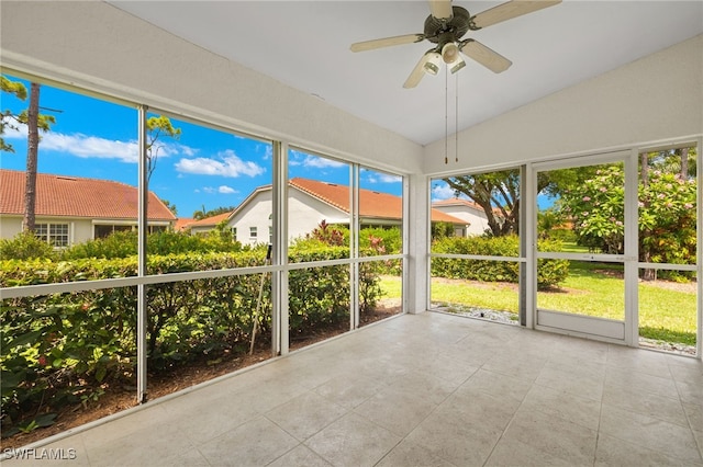 unfurnished sunroom with ceiling fan and lofted ceiling