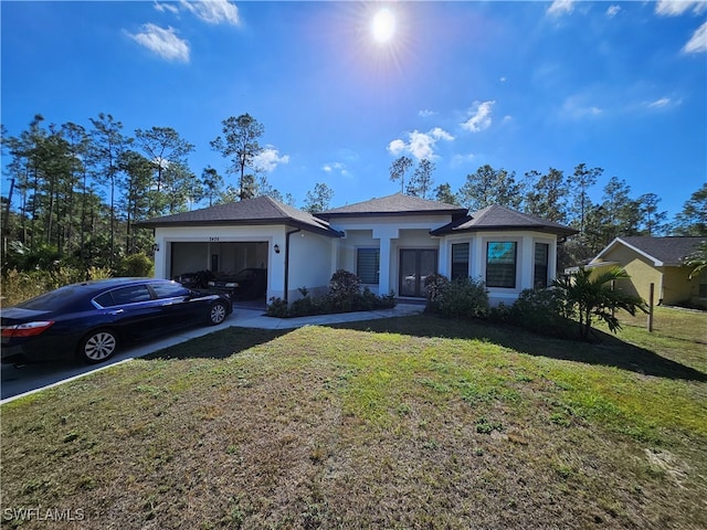 view of front of home featuring a front yard and a garage