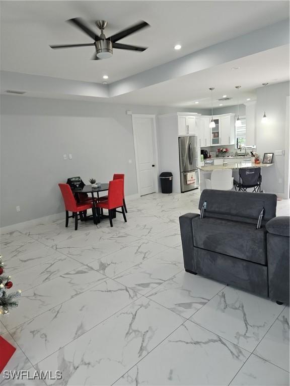 living room with a ceiling fan and recessed lighting