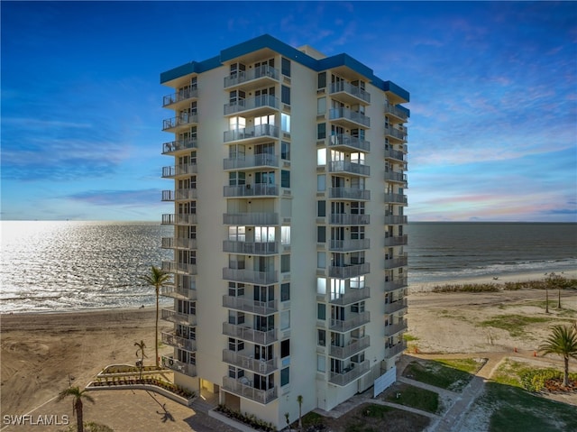 outdoor building at dusk with a view of the beach and a water view