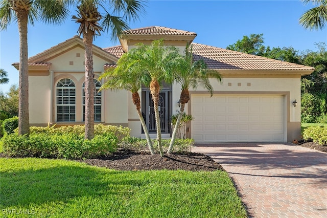 mediterranean / spanish-style house with a garage