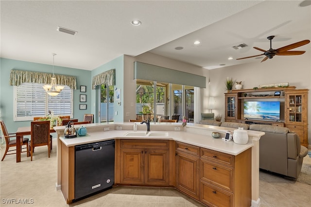 kitchen with sink, black dishwasher, decorative light fixtures, a center island with sink, and ceiling fan with notable chandelier