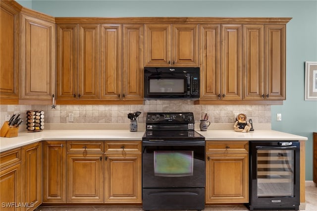 kitchen with decorative backsplash, light tile patterned floors, beverage cooler, and black appliances