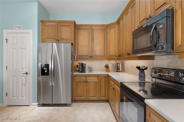 kitchen featuring black appliances and decorative backsplash