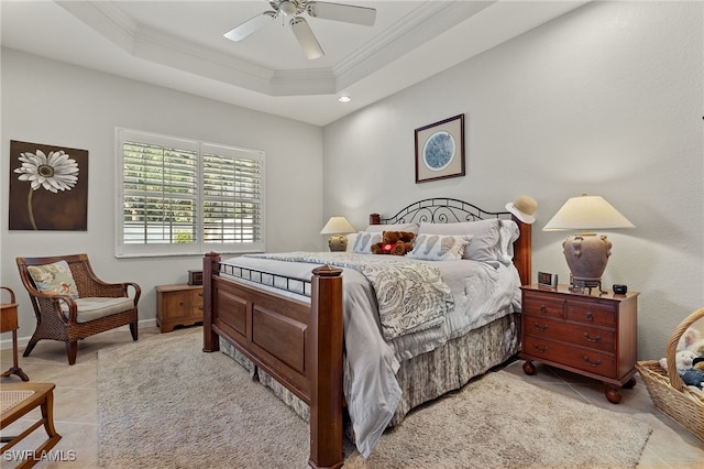 bedroom with a tray ceiling, ceiling fan, light tile patterned floors, and ornamental molding