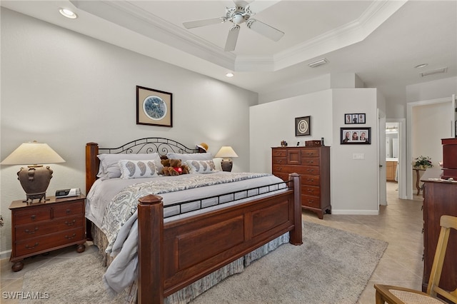 tiled bedroom with ceiling fan, ensuite bath, ornamental molding, and a tray ceiling