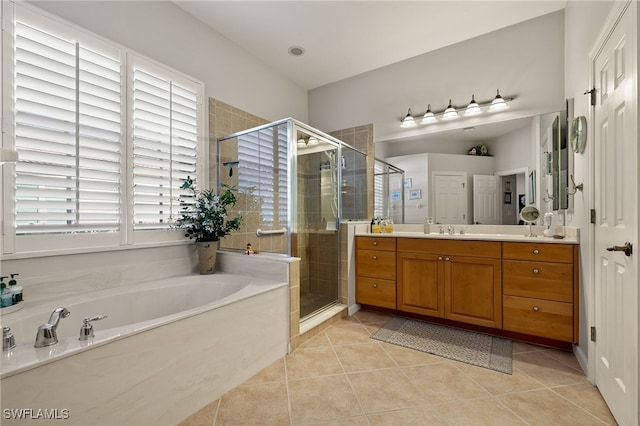 bathroom with tile patterned floors, vanity, and separate shower and tub