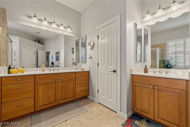 bathroom with tile patterned floors, vanity, and walk in shower