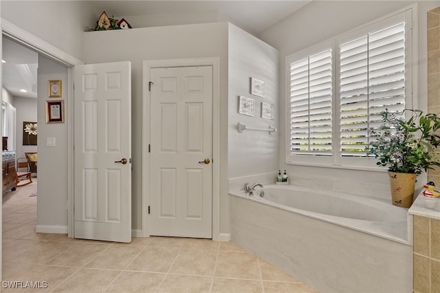 bathroom with tile patterned floors and a bathtub