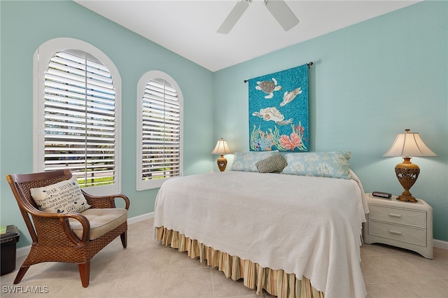 tiled bedroom featuring ceiling fan