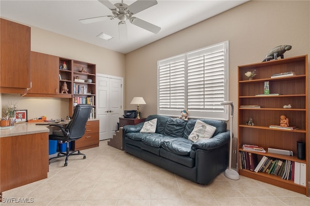 tiled office space featuring ceiling fan