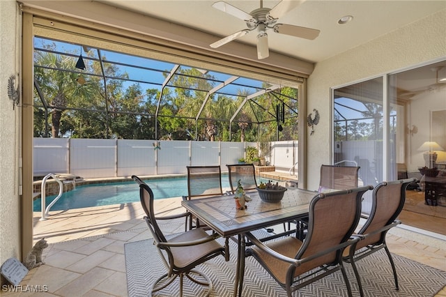 interior space with a fenced in pool, glass enclosure, ceiling fan, and pool water feature