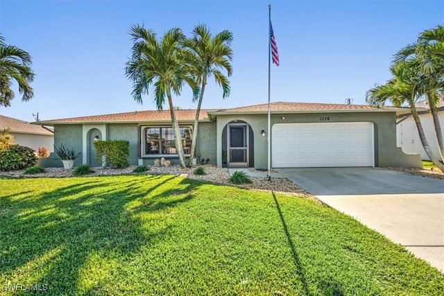 single story home featuring a garage and a front lawn