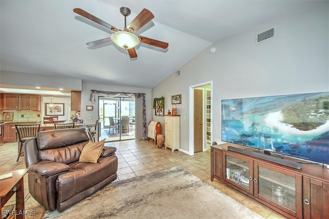 tiled living room featuring ceiling fan and lofted ceiling