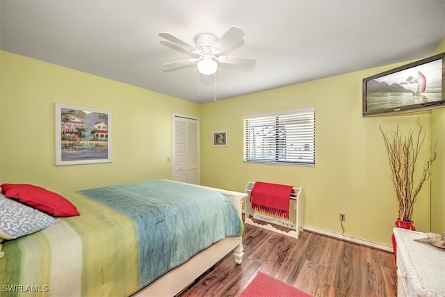 bedroom with hardwood / wood-style floors, a closet, and ceiling fan