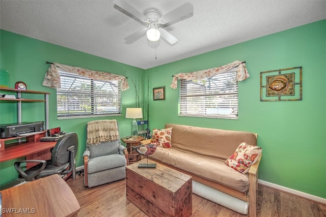 office area with plenty of natural light, ceiling fan, a textured ceiling, and light hardwood / wood-style flooring