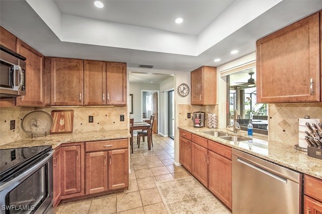 kitchen with decorative backsplash, sink, and appliances with stainless steel finishes