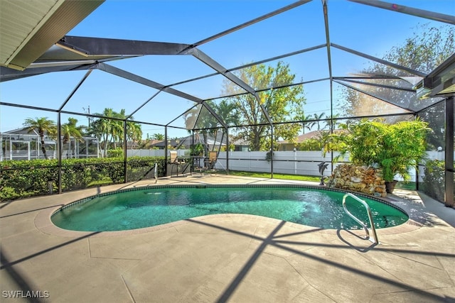 view of swimming pool with glass enclosure and a patio area