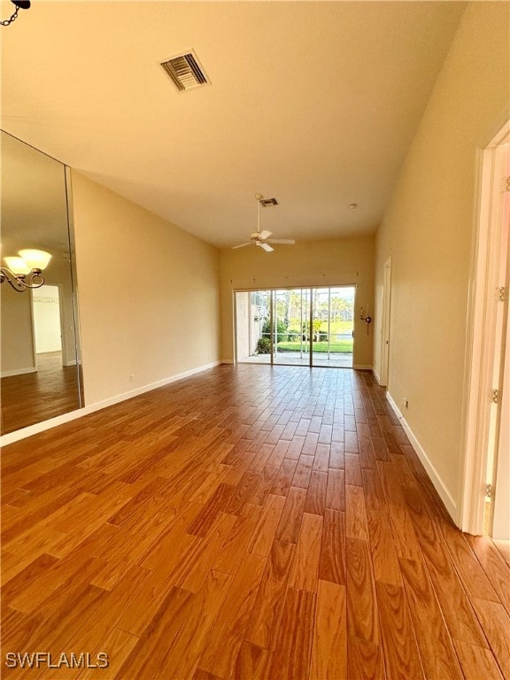 empty room with ceiling fan and wood-type flooring