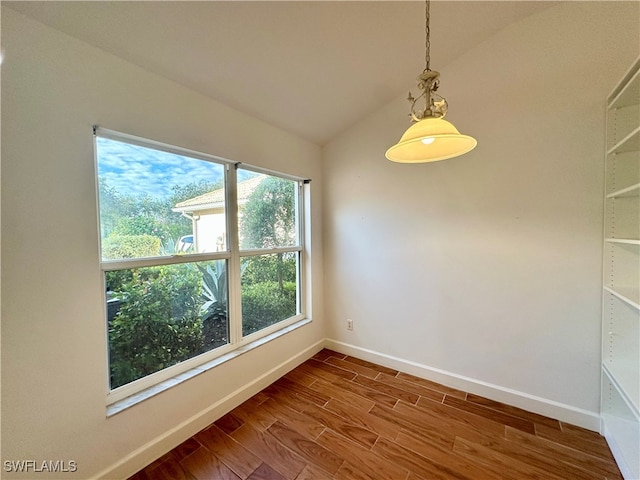 unfurnished room with wood-type flooring and vaulted ceiling